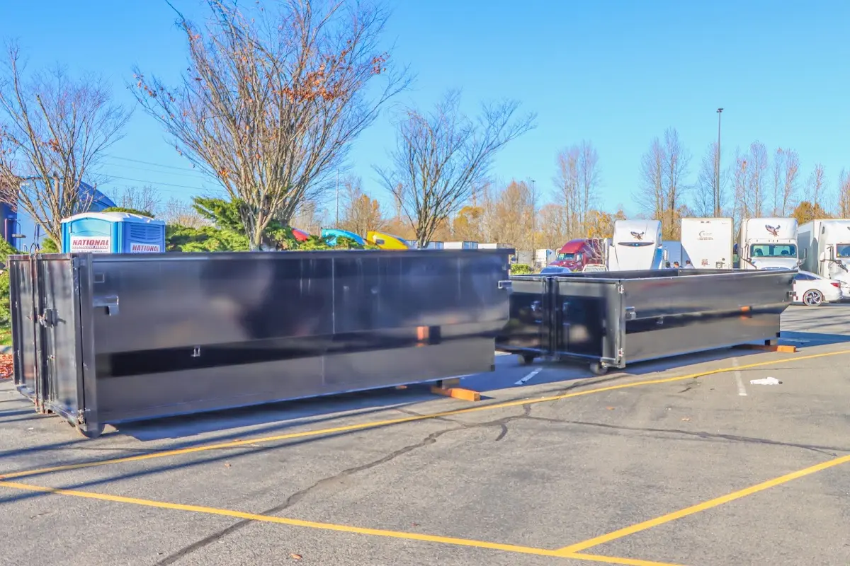 Professional dumpster rental service with roll-off container on residential driveway in Port Jervis